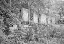 Wall of home built on top of wall as shown in 1900s photo above.