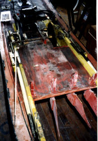 Lower deck showing rudders, location for wheel, and engine room area with electric motor used to turn wheel.