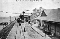 Postcard dated 1910 shows the train depot with the boats on the river near the Ferry entrance