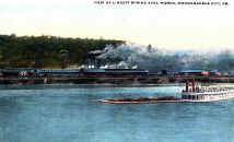 Monongahela Axle Works with unrealistic boat and barge in foreground.  Postcard is dated during 1930s.