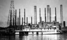 Steamer RESOLUTE built in 1914 in front of a Duquesne Power Plant